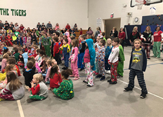large group students in the gym wearing their pajamas